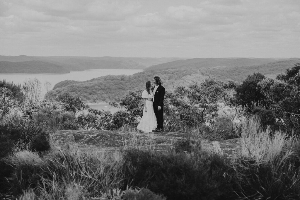 Best places to elope around Sydney. Central Coast Elopement near Patonga. Black and white image of a couple gazing at a view over the Hawkesbury River