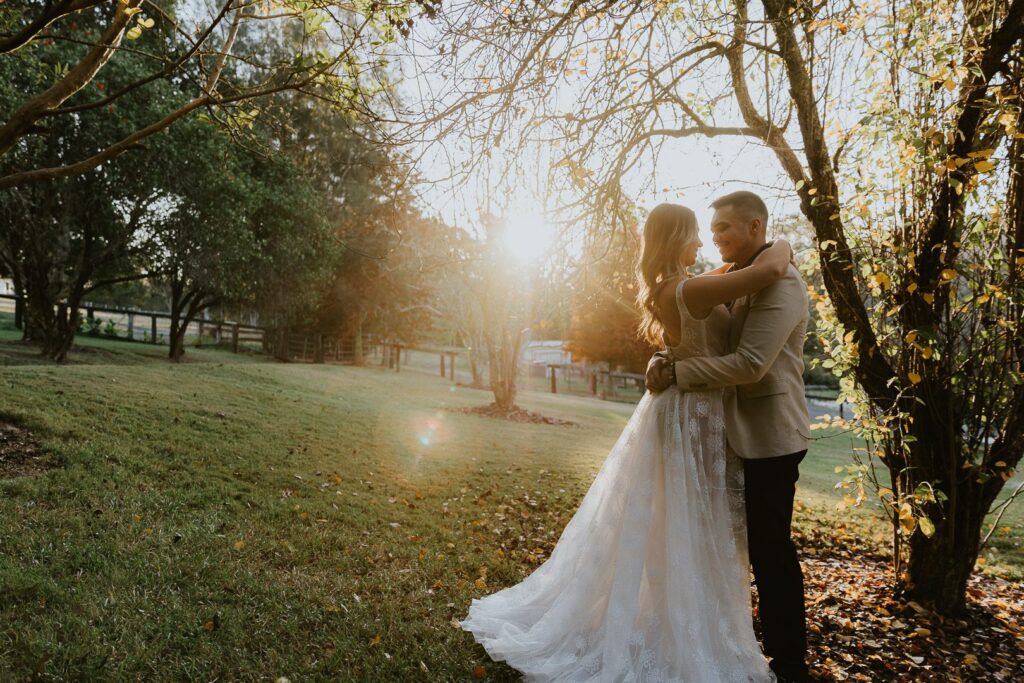 couple in sunset with the sun behind them on their wedding day